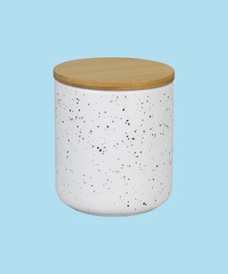 White speckled Natura candle with bamboo lid.