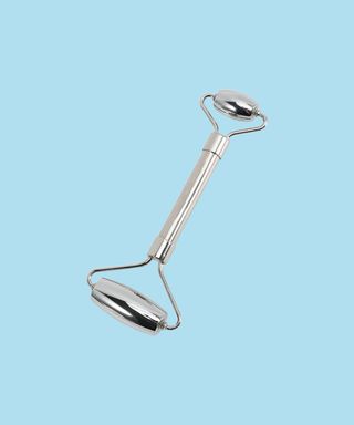 Stainless steel facial roller in silver.
