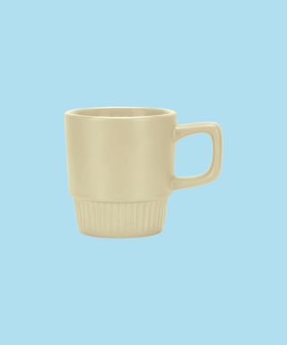 Ecru Barista Stackable Coffee Mug on a light blue background.