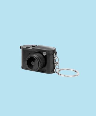 Black Candid Mini Camera shown from a side angle with keyring.